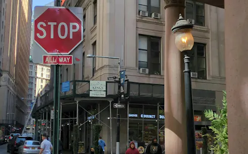 Stop sign at Beaver Street intersection in Downtown New York, part of Ghost of Wall Street exploration game.