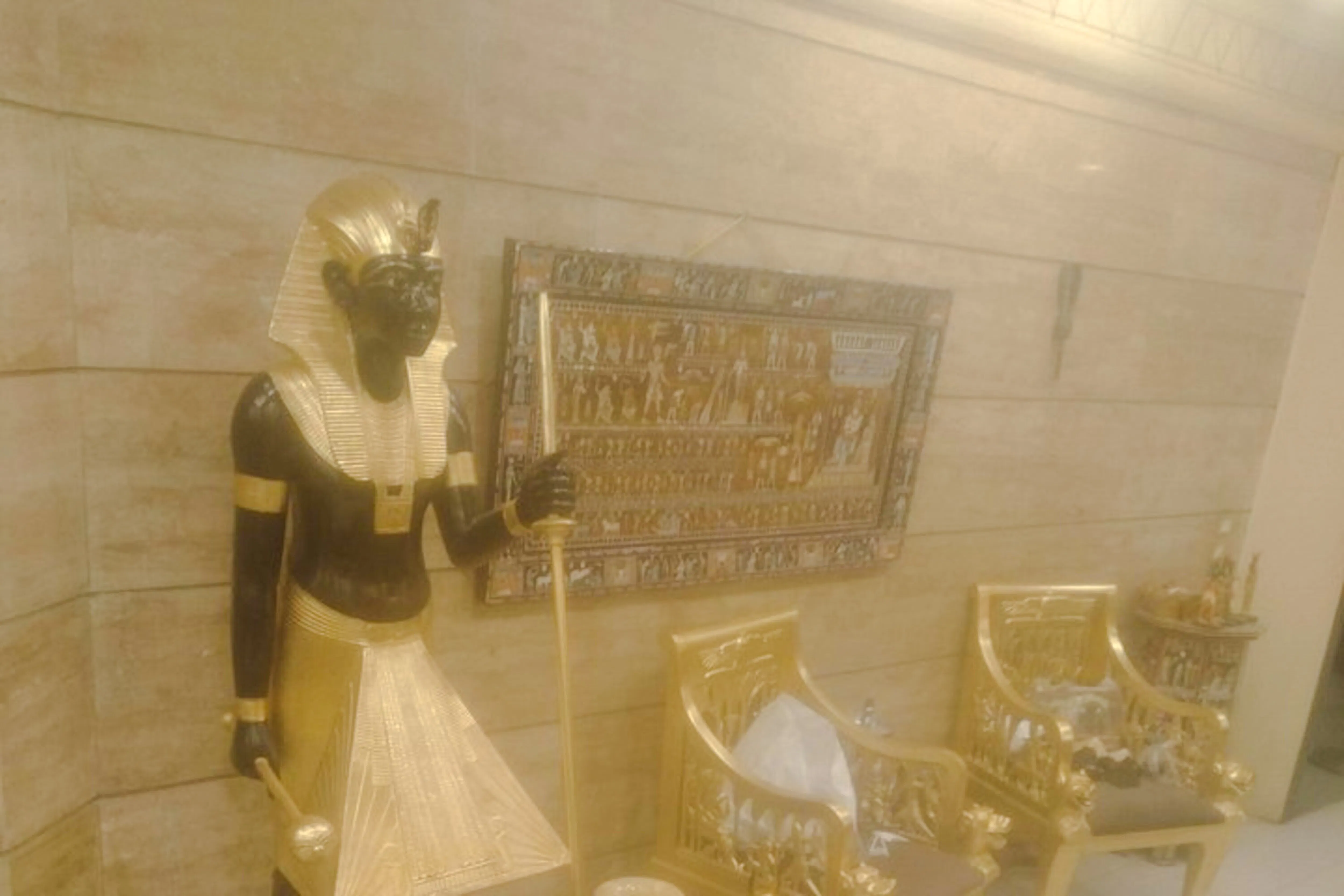 Pharaoh statue and hieroglyphic art in Khan el-Khalili, Cairo.