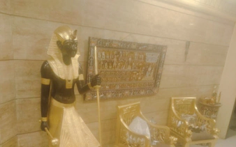 Pharaoh statue and hieroglyphic art in Khan el-Khalili, Cairo.
