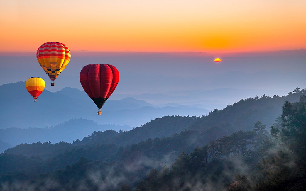 Hot air balloons over Doi Luang Chiang Dao at sunrise, Chiang Mai.