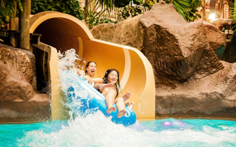 People enjoying a water slide at Alton Towers Waterpark.