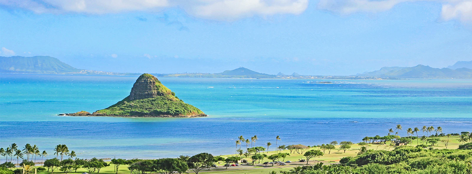 Chinaman's Hat island in Kaneohe Bay, Oahu, Hawaii, with lush greenery and ocean view.