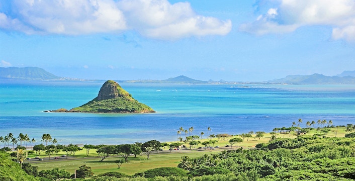 Chinaman's Hat island in Kaneohe Bay, Oahu, Hawaii, with lush greenery and ocean view.
