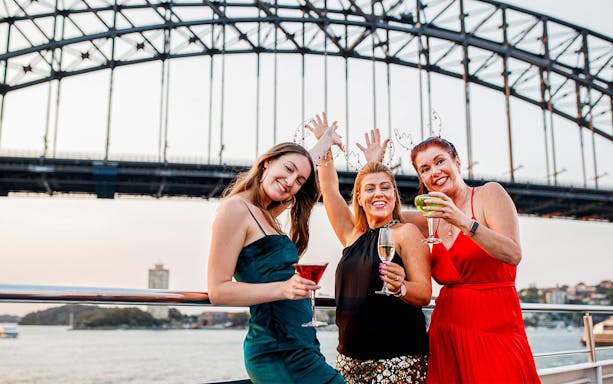Passengers celebrating on Sydney Christmas Day Lunch Cruise with Harbour Bridge.