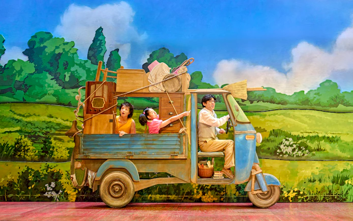 Family in a truck with household items, My Neighbour Totoro production scene.