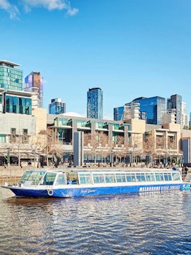 Williamstown Ferry cruising on Yarra River with Melbourne skyline in the background.