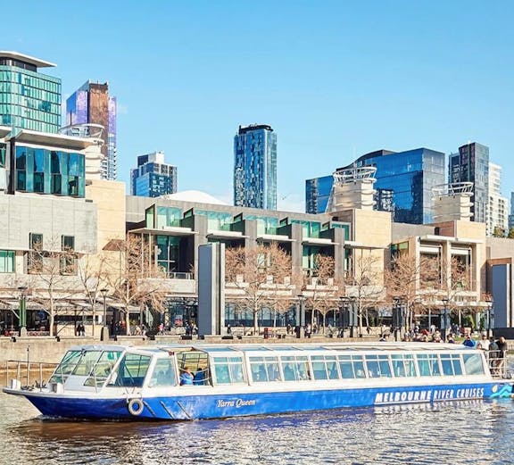 Williamstown Ferry cruising on Yarra River with Melbourne skyline in the background.