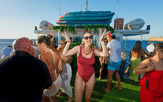 Tourists dancing on a boat during Ibiza to Formentera cruise with breakfast and lunch.