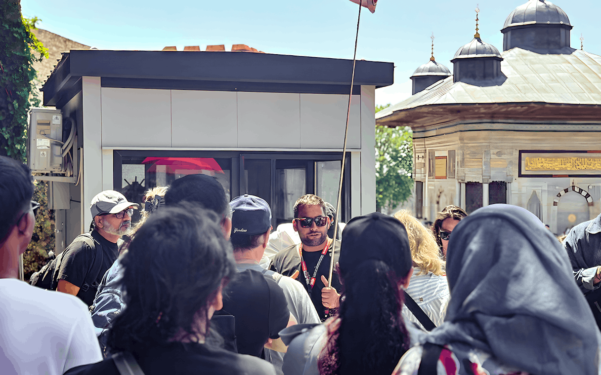 Tour guide leading a group near the Blue Mosque in Istanbul.