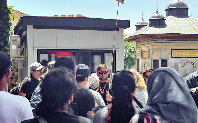 Tour guide leading a group near the Blue Mosque in Istanbul.