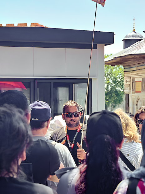 Tour guide leading a group near the Blue Mosque in Istanbul.