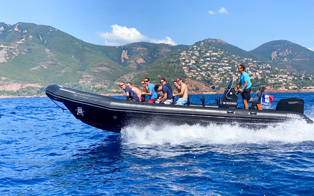 Boat tour group exploring Estérel Natural Park from Cannes.