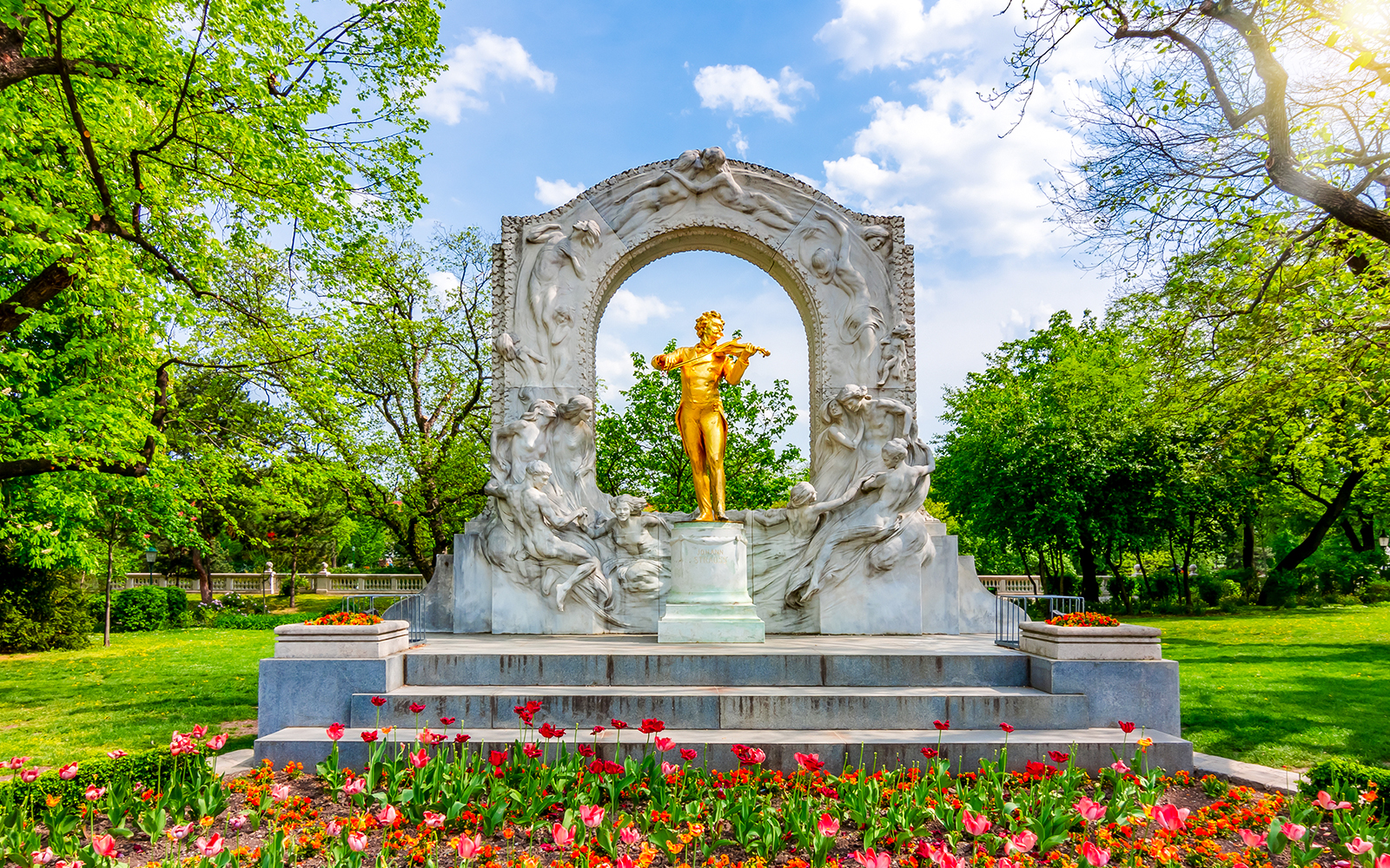 Monumento a Johann Strauss cercado por flores desabrochando no Stadtpark, Viena, Áustria.
