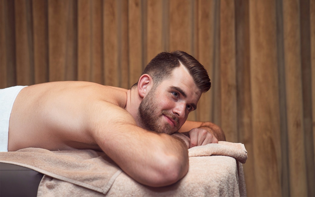 Man relaxing on a massage table during a Turkish bath experience in Taksim, Istanbul.