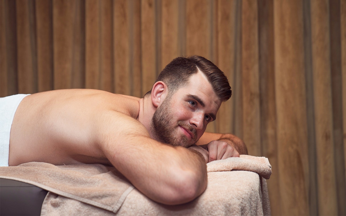 Man relaxing on a massage table during a Turkish bath experience in Taksim, Istanbul.