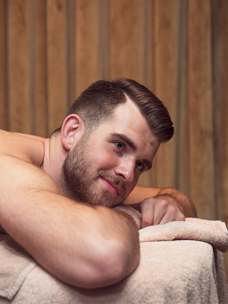 Man relaxing on a massage table during a Turkish bath experience in Taksim, Istanbul.