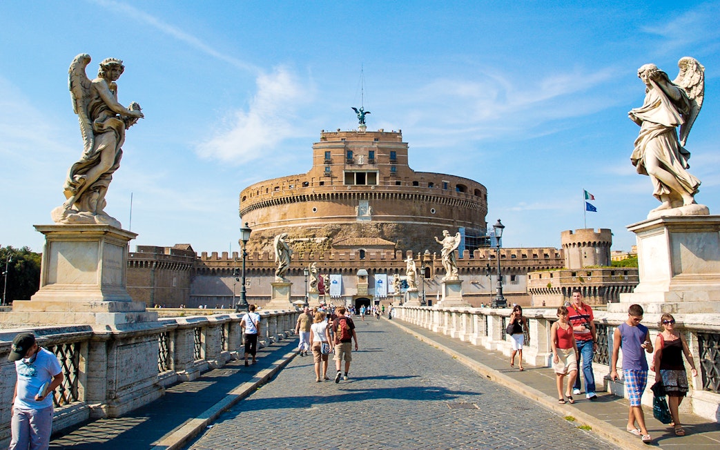 Visitors walking on the bridge towards Castel Sant'Angelo in Rome, Italy.
