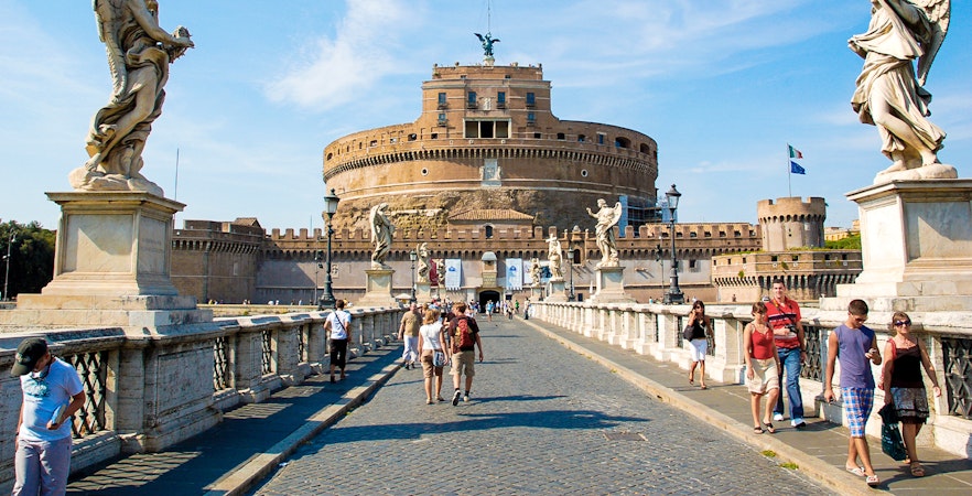 Visitors walking on the bridge towards Castel Sant'Angelo in Rome, Italy.
