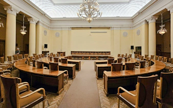 Conference room with wooden chairs and tables inside Palace of Culture and Science, Warsaw.
