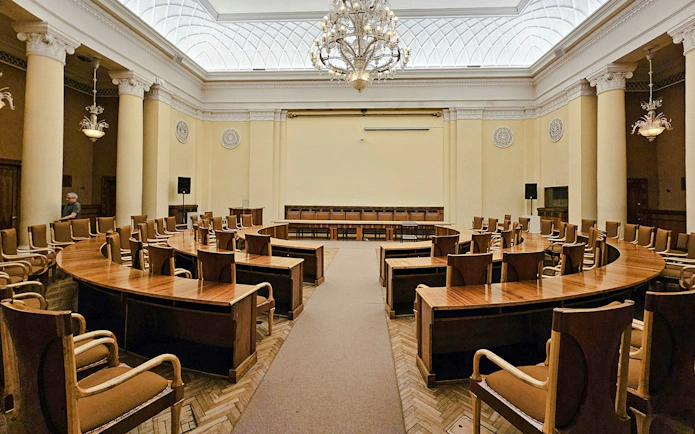 Conference room with wooden chairs and tables inside Palace of Culture and Science, Warsaw.