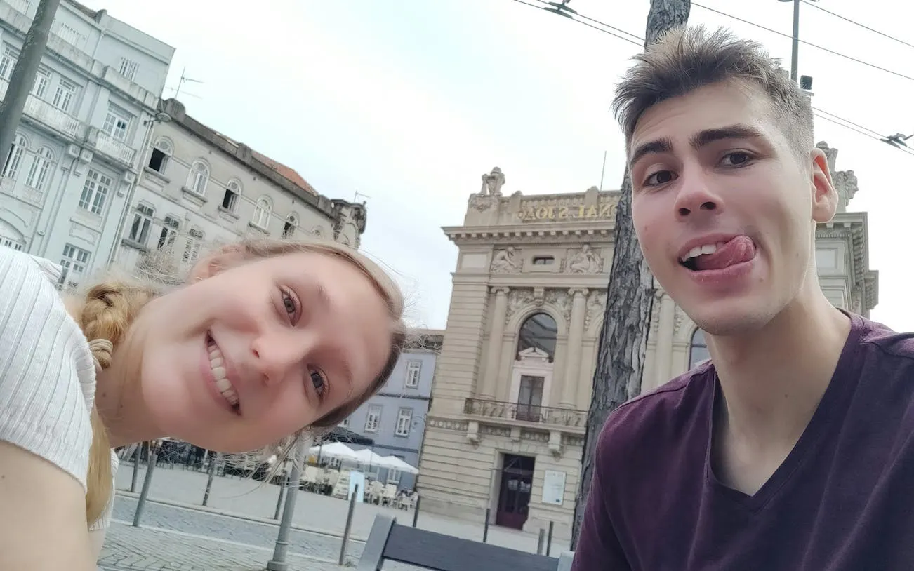 Couple enjoying Porto’s Old Town with historic architecture in the background.