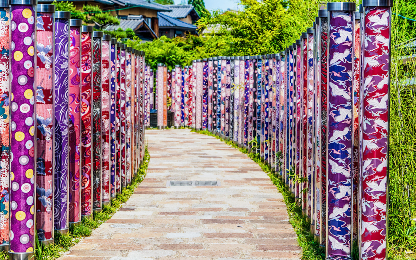 Kimono Forest art installation with colorful fabric pillars in Arashiyama, Kyoto, Japan.
