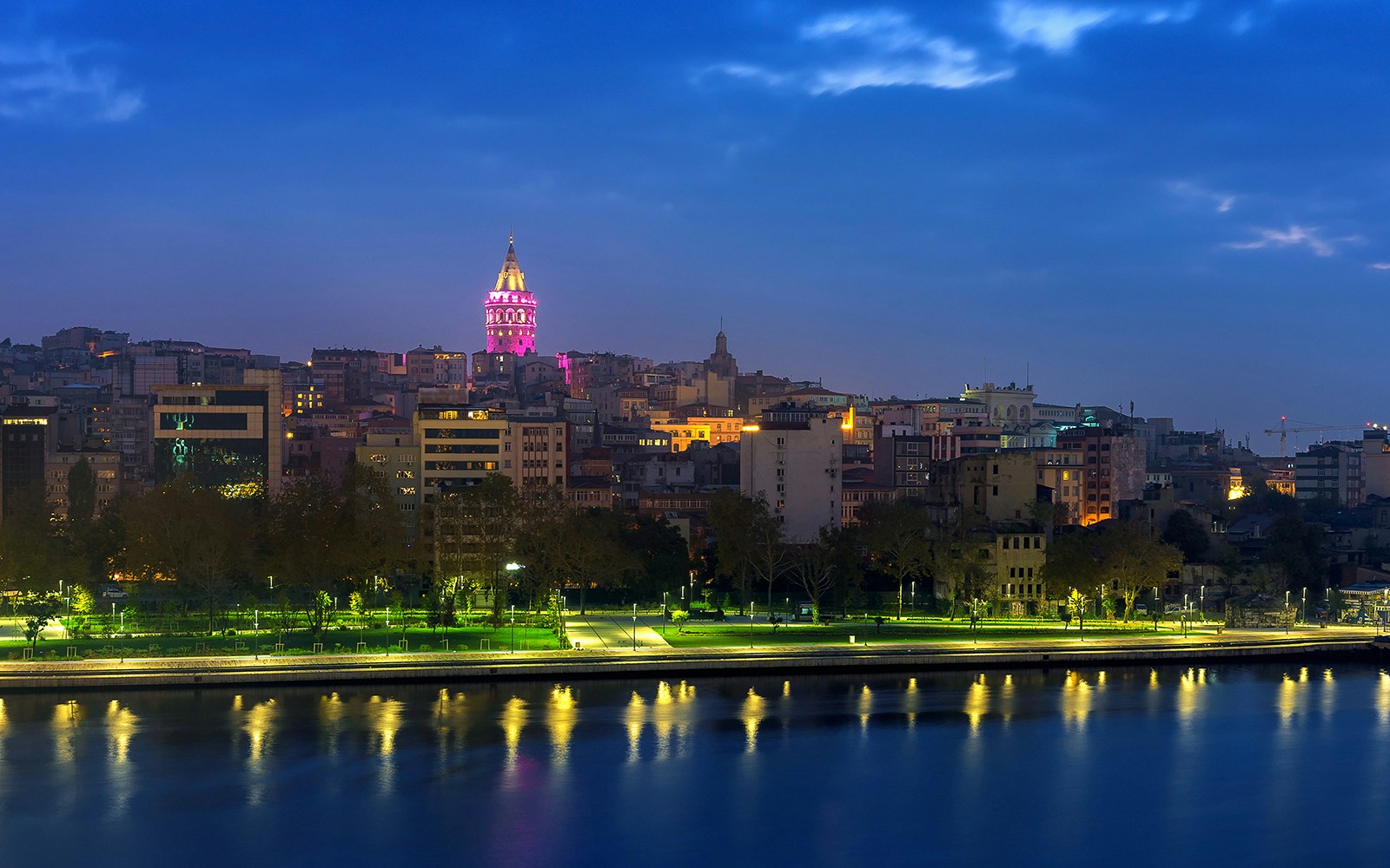 Galata Tower illuminated at night near the Bosphorus Strait, Istanbul.