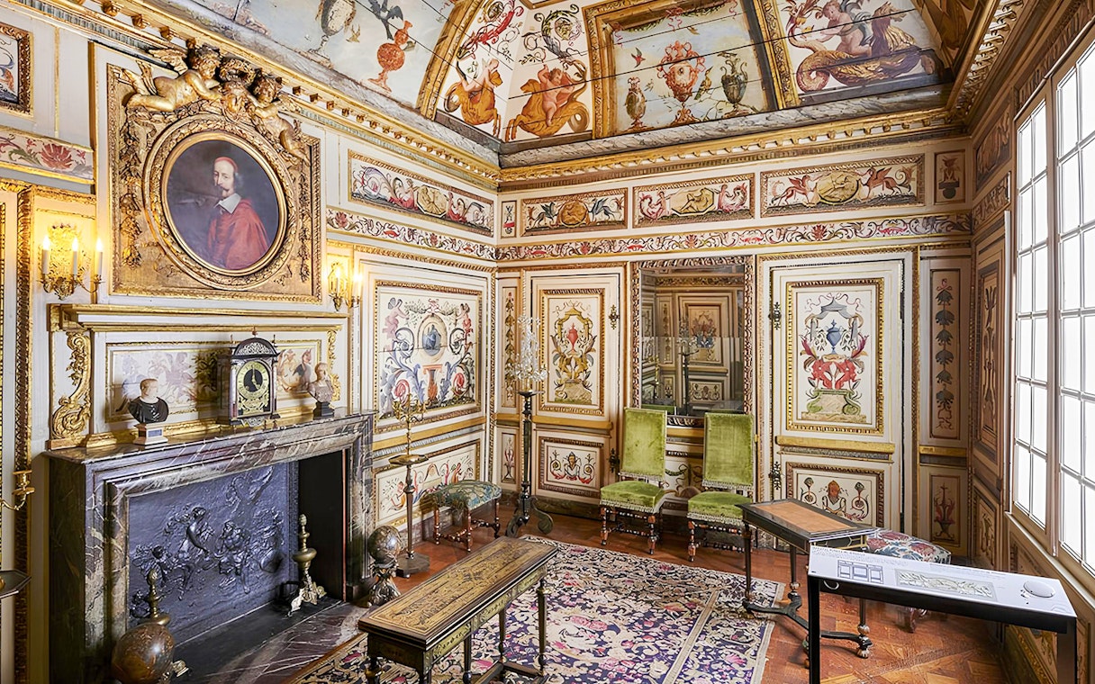 Carnavalet Museum ornate room with historical paintings and antique furniture in Paris.