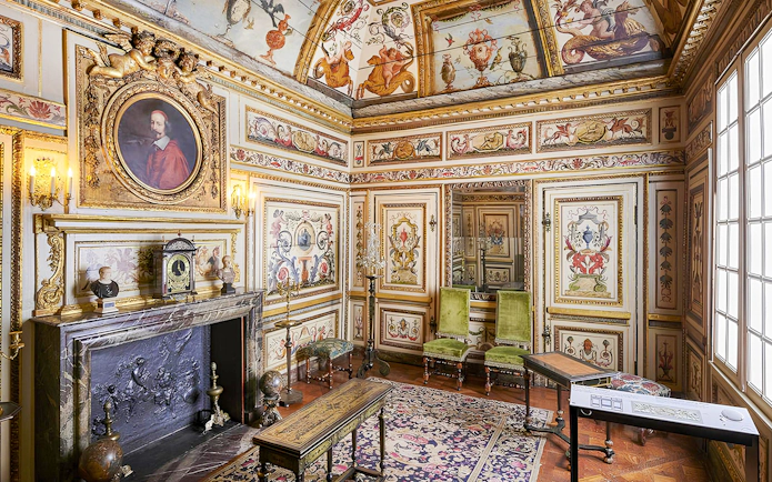 Carnavalet Museum ornate room with historical paintings and antique furniture in Paris.