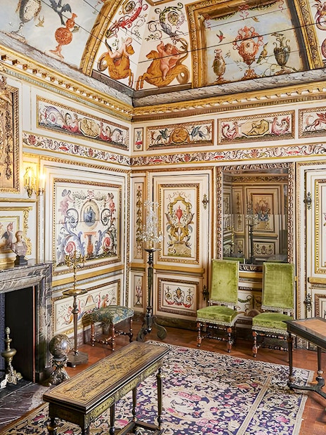 Carnavalet Museum ornate room with historical paintings and antique furniture in Paris.