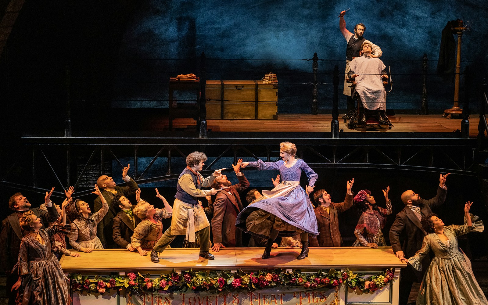 Stage performance of Sweeney Todd with actors in period costumes, featuring a barber scene.