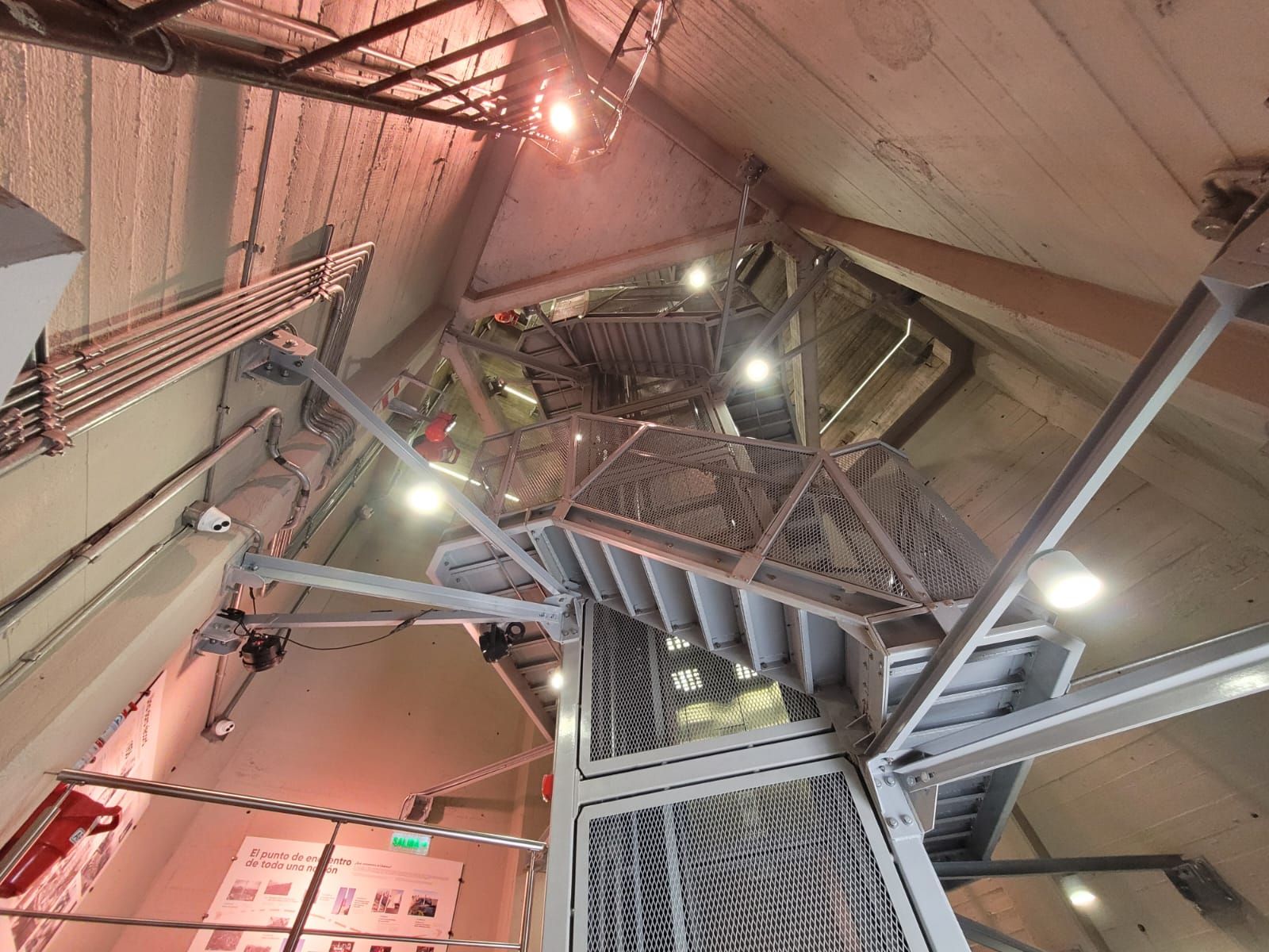 Interior metal stairs of Obelisco de Buenos Aires with visible lighting and structural details.