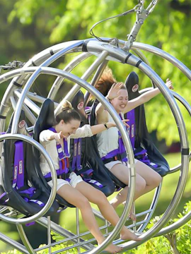 Two people enjoying a thrilling ride on the Slingshot in Singapore.