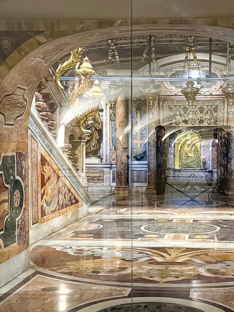 St. Peter's Basilica Grottoes with ornate tomb and intricate marble designs.