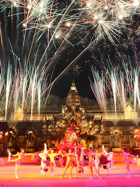 Fireworks over performers in Thai costumes dancing at Phuket Fantasea temple.