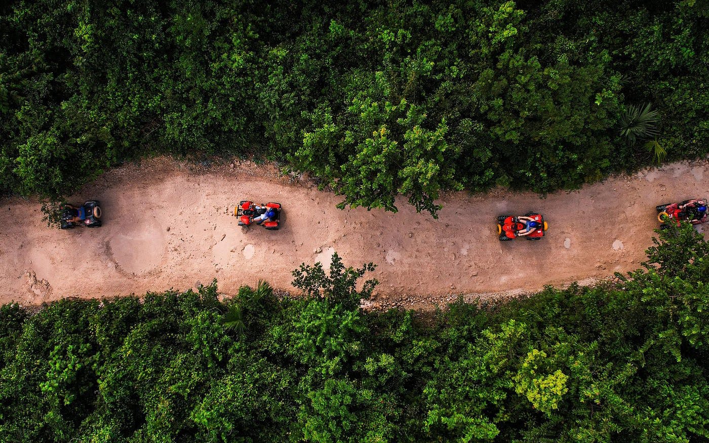 ATVs driving through a jungle trail in Cancun.