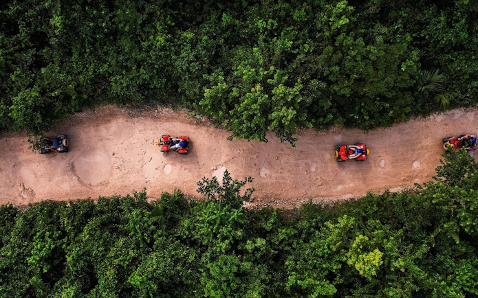 ATVs driving through a jungle trail in Cancun.