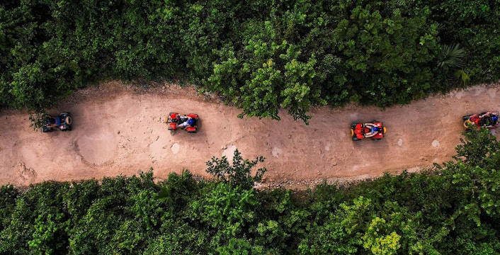 ATVs driving through a jungle trail in Cancun.