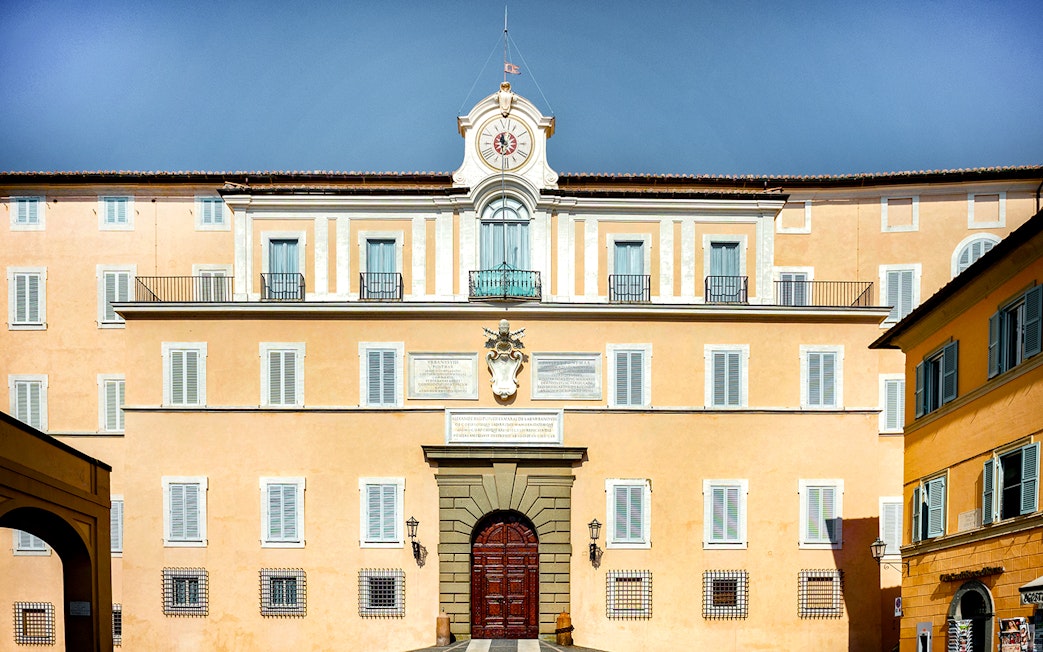 Castel Gandolfo facade with clock tower in Vatican City.