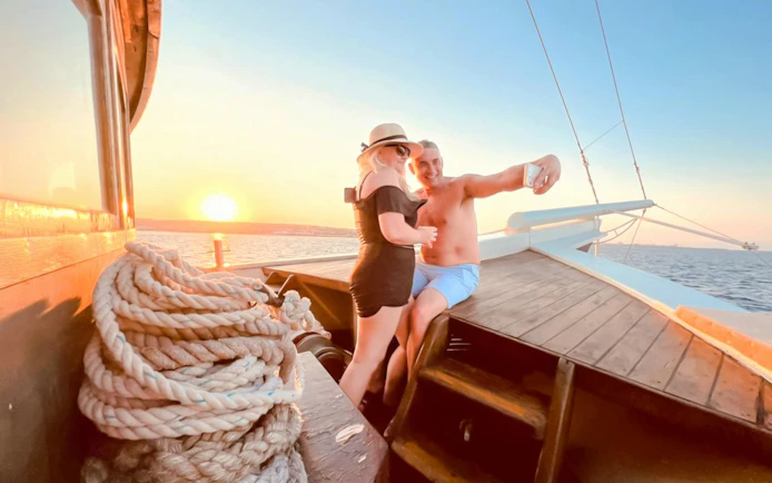 Guests enjoying sunset on deck during Rhodes cruise.