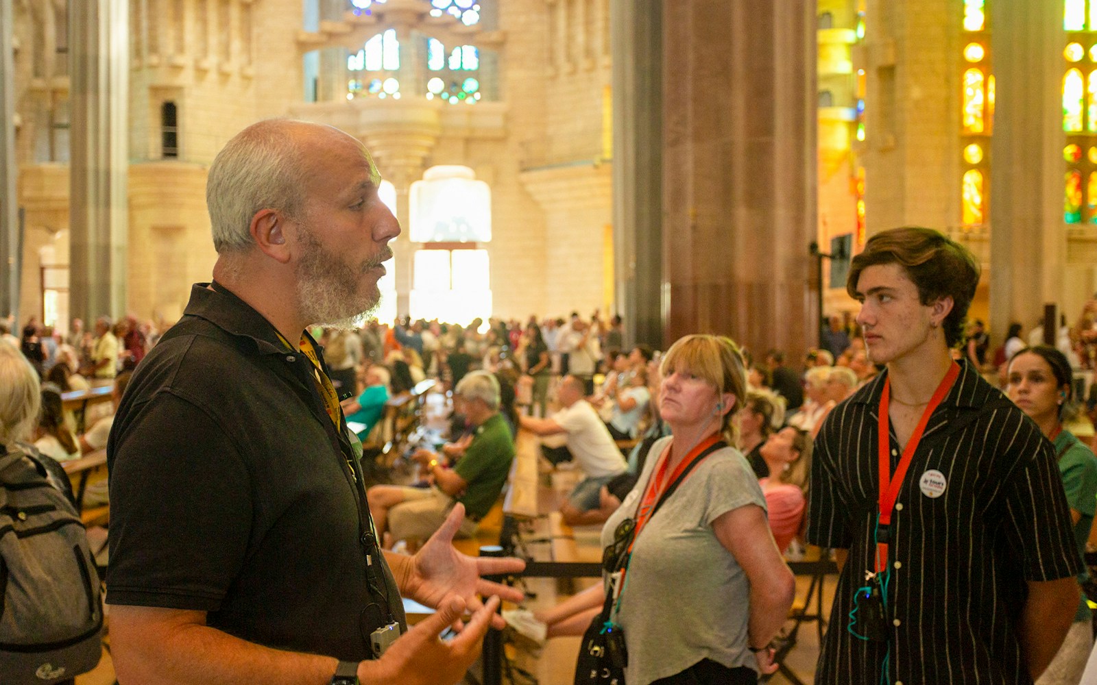 Tour guide explaining Sagrada Familia details to visitors in Barcelona.