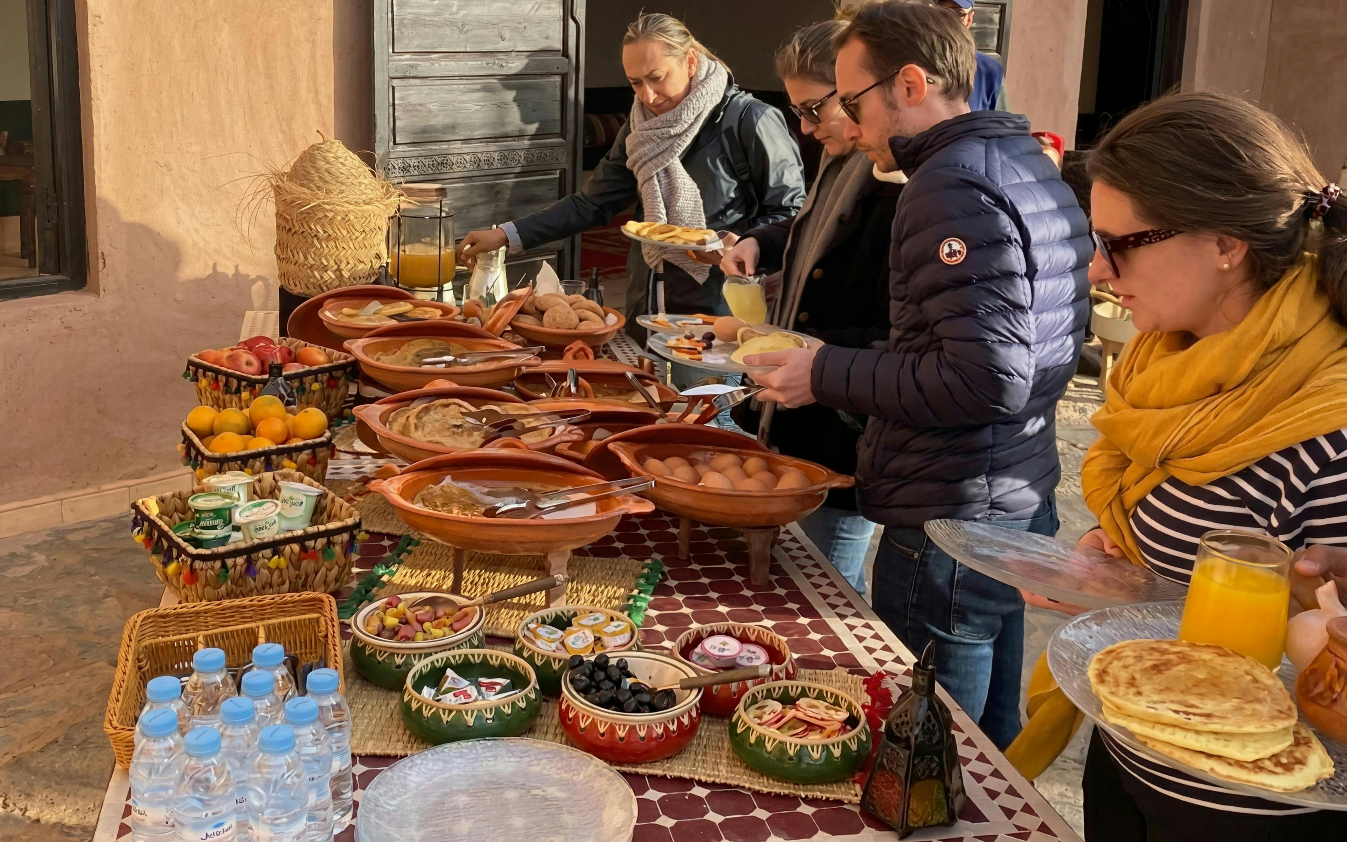 Berber breakfast spread with traditional dishes and fruits in Marrakech.