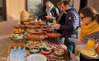 Berber breakfast spread with traditional dishes and fruits in Marrakech.