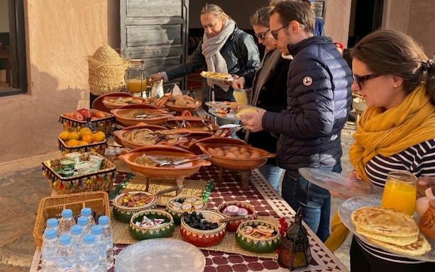 Berber breakfast spread with traditional dishes and fruits in Marrakech.