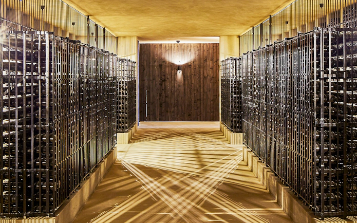 Wine cellar at Cockburn's Port Lodge with rows of wine bottles in Porto, Portugal.