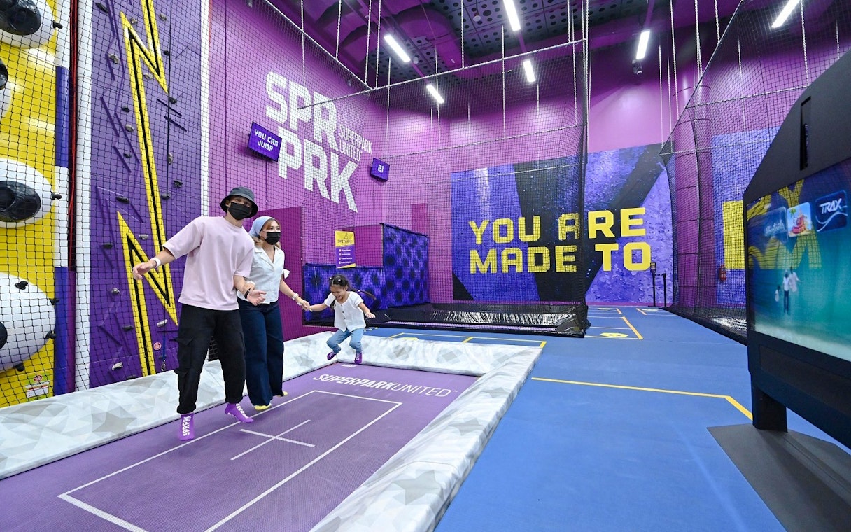 Family enjoying trampoline activity at SuperPark Singapore.