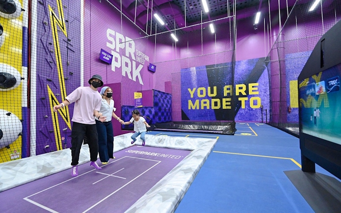 Family enjoying trampoline activity at SuperPark Singapore.