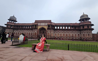 Visitor in traditional attire at Agra Fort during Taj Mahal sunrise tour, Agra.