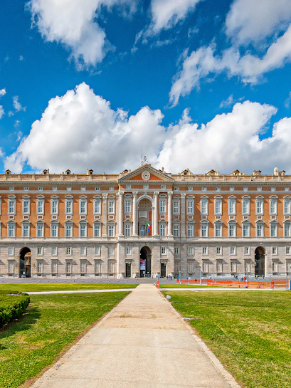 Royal Palace of Caserta facade with blue sky and clouds in Caserta, Italy.
