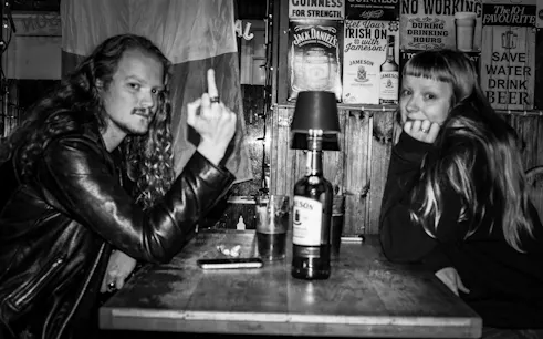 Reykjavík punk history tour participants at a local bar with vintage decor.